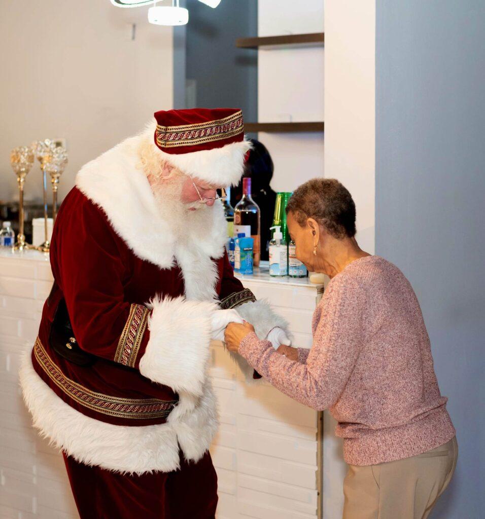 Santa John of Georgia dancing with a senior citizen.